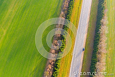 Highway going along green farmlands. Aerial view Stock Photo