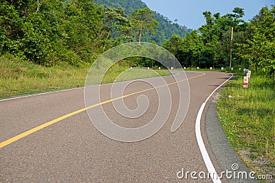 Empty highway in green summer landscape. Straight road in wild forest. Summer outdoor travel landscape. Stock Photo