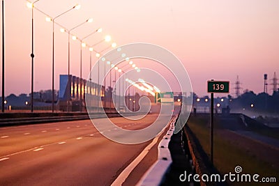 Empty highway stretching into the distance at sunrise Stock Photo