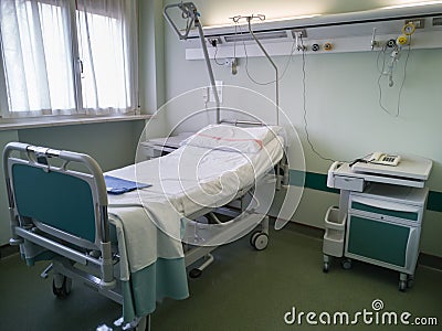 Empty Hospital Clinic Room with Bed, Drawer unit and Window Stock Photo
