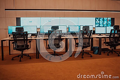Empty interior of big modern security system control room, workstation with multiple displays, monitoring room with at Stock Photo