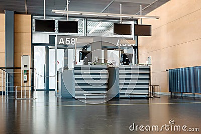 Empty international airport gate front desk with numbered signs in peak season during global pandemic Stock Photo