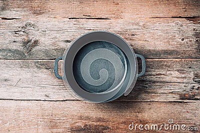 Empty iron pot on wooden background. Top view. Copy space. Healthy, clean food and eating concept. Zero waste. Cooking frame Stock Photo