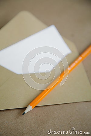 Empty letter and pencil. Brown vintage background Stock Photo