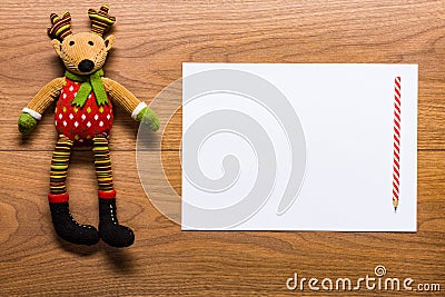 Empty letter to santa on a desk with cute reindeer toy Stock Photo