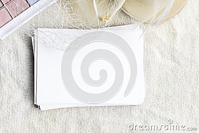 An empty letterhead and a white hat with a veil. Female wedding background Stock Photo