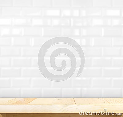 Empty light wood table and white ceramic tile brick wall in back Stock Photo