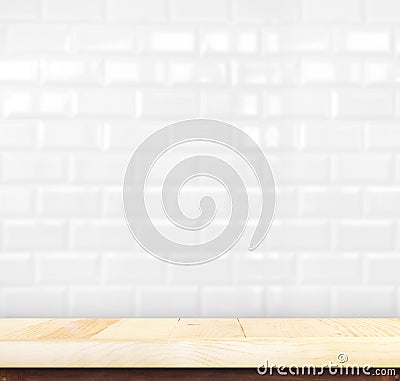 Empty light wood table and white ceramic tile brick wall in back Stock Photo