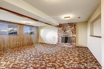 Empty living room with brick fireplace and colorful carpet floor Stock Photo