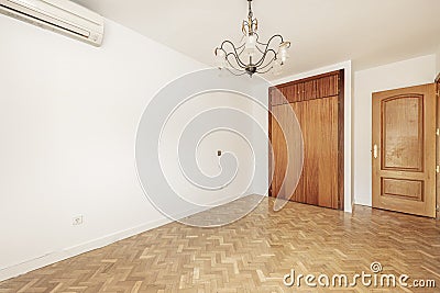 empty living room with built-in wooden wardrobe with air conditioner, Stock Photo