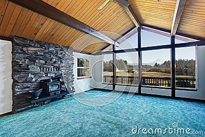 Empty living room with turquoise carpet floor in luxury house. Stock Photo