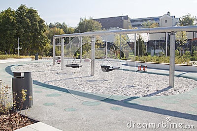 empty lonely swings in a modern park Stock Photo