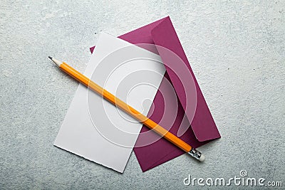 An empty love letter to Valentine`s Day. Paper, pink envelope and pencil on a white vintage desk, space for text Stock Photo