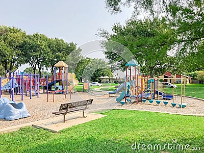 Empty metal bench at colorful playground near residential neighborhood in Richardson, Texas, USA Editorial Stock Photo