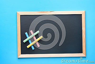 Empty Mock Up Black Chalkboard with Hashtag Sign Made from Multicolored Chalks Blue Background. Back to School Concept Education Stock Photo