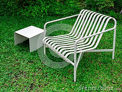 Empty modern minimal design of white empty curved armchair seat and small square side table. Stock Photo