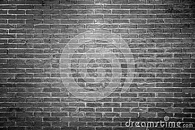 Empty monochrome brick wall background texture with spot light in the middle. Stock Photo