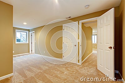 Empty new bedroom with many doors and beige carpet. Stock Photo