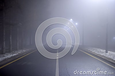 Empty night road with dense fog. Dangerous driving conditions Stock Photo