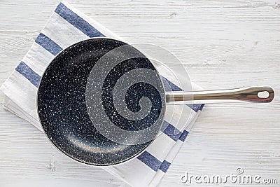 Empty Nonstick Frying Pan Skillet on a white wooden background Stock Photo