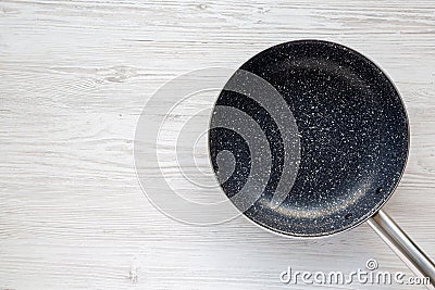 Empty Nonstick Frying Pan Skillet on a white wooden background. Space for text Stock Photo