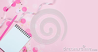 Empty note pad on pink festive background with confetti and sparkles. Stock Photo