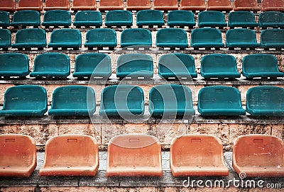 Empty old plastic seats at stadium, open door sports arena. Stock Photo