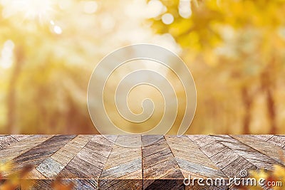 Empty old rustic wood plank table top with blur forest tree with sunlight,Autumn fall backgorund,Mock up for display or montage of Stock Photo