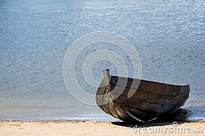 Empty old wooden rowboat on the beach Stock Photo