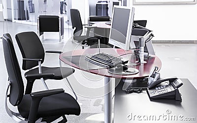 Empty open-plan office with desks chairs computers Stock Photo