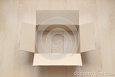 Empty open rectangular cardboard box on wood. Stock Photo