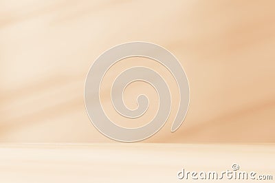 Empty orange brown cream beige room studio with shadow of leaves for product presentation. Stock Photo