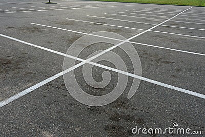 Empty outdoor dirty parking lot space marked with white lines Stock Photo