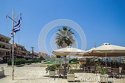 Empty outdoor seafront cafes with chairs and tables at summer in Lixouri Town on the Ionian Island of Cephalonia Greece Stock Photo