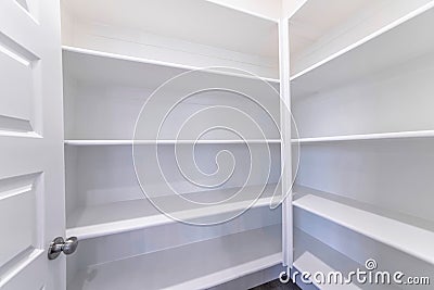 Empty pantry of house with built in shelves for storage and organization of food Stock Photo