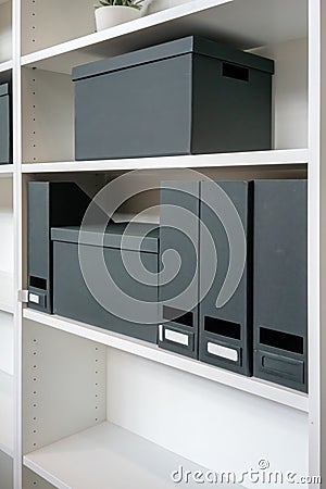 Empty paper filing box and file holder on shelf. Stock Photo