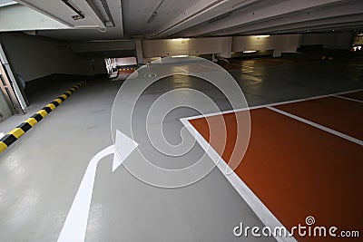 Empty parking garage with arrow for left or straight ahead Stock Photo