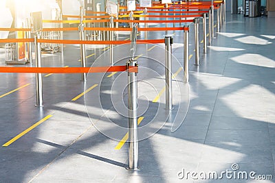 Empty paths bounded by a red ribbon to the check-in desks and baggage claim at the passenger airport terminal Stock Photo