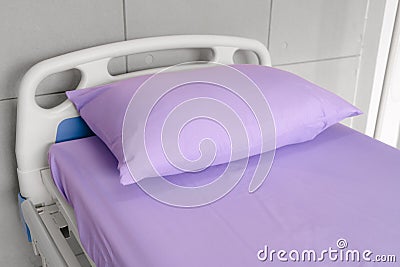 Empty patient bed in hospital room. Bed is for patient admitted to hospital Stock Photo
