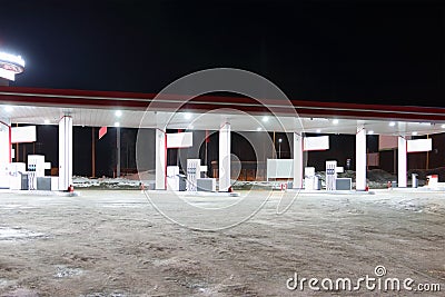 Empty petrol station with illumination at dark winter night Stock Photo