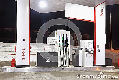 Empty petrol station with illumination and guns at winter Stock Photo