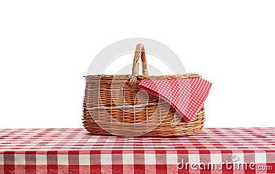 Empty picnic basket on checkered tablecloth Stock Photo