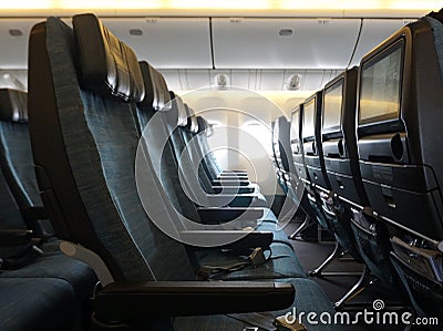 Empty plane cabin seat with green uphostery Stock Photo