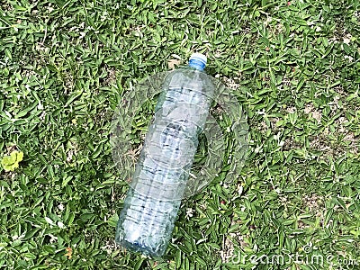 Empty plastic bottle close-up on green grass top view. Plastic garbage. Recycling. Ecological situation. Separation trash Stock Photo
