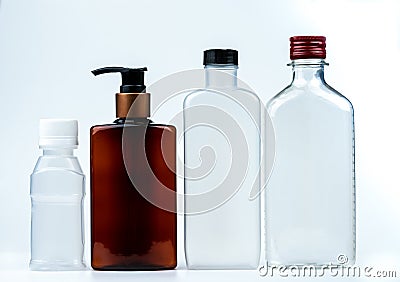 Empty plastic and glass bottle with cap and pump with black label isolated on white background. Pharmaceutical products bottle Stock Photo