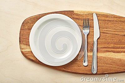 Empty plate and chopping board on table. Top view. Stock Photo