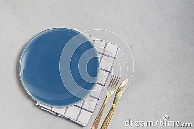 Empty plate and kitchen textile napkin with silverwear Stock Photo