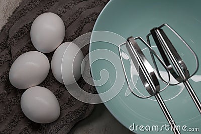 Empty plate, mixer, eggs on a towel. Preparation for whipping eggs for dough, dessert Stock Photo