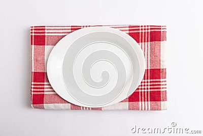 Empty plate on red checkered textile Stock Photo