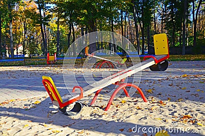 Empty playground with carousels and swings on a warm sunny autumn day Stock Photo